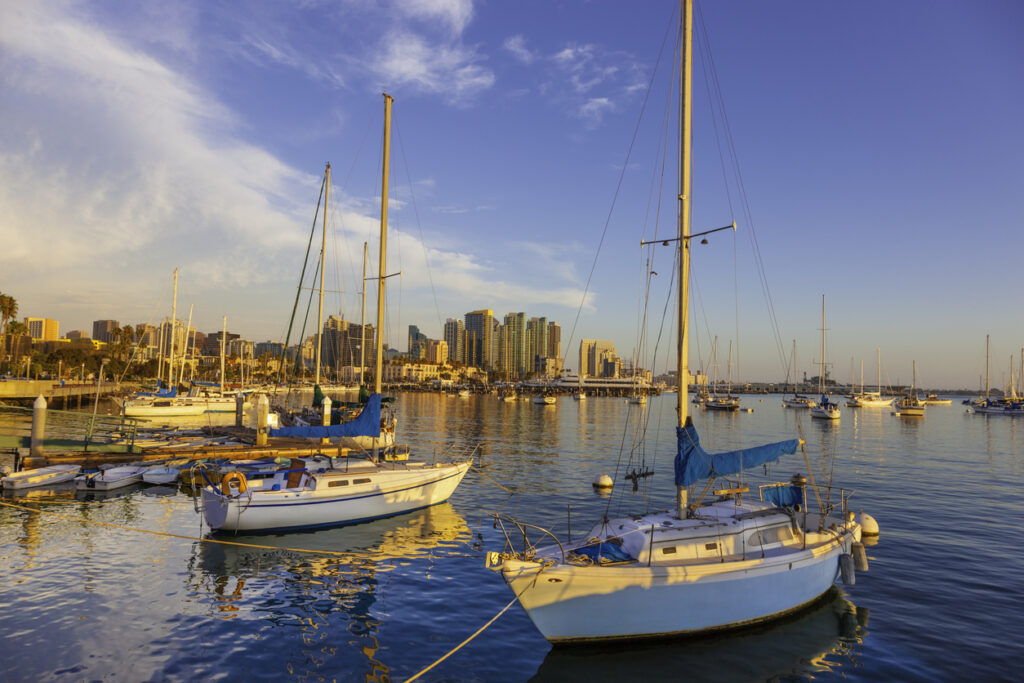 Boat insurance San Diego: Setting sun cast a warm glow on the skyline of San Diego, California